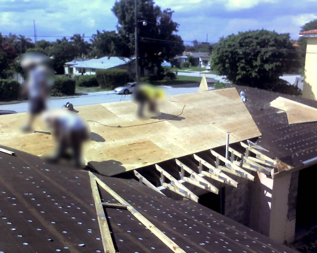 Plywood being installed on new roof of garge conversion